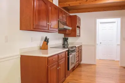 a kitchen with wooden cabinets and a stove top oven at Hunter's Cove in Morehead