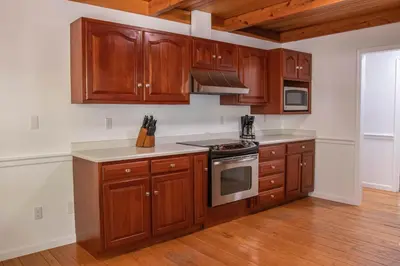 a kitchen with wooden cabinets and a stove top oven at Hunter's Cove in Morehead