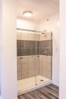 a bathroom with a glass shower with a tub at Hunter's Cove in Morehead
