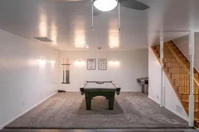 a pool table in a room with a staircase at Hunter's Cove in Morehead