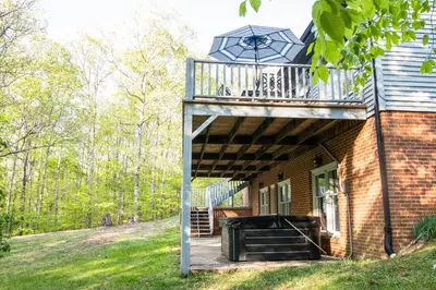 a deck on the side of a building with a staircase at Hunter's Cove in Morehead