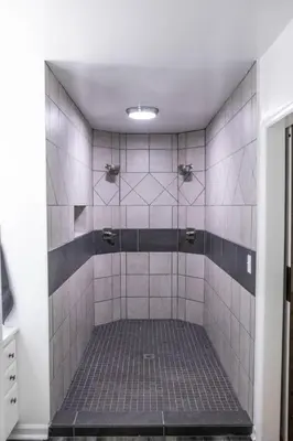 a bathroom with a shower with white tiles at Hunter's Cove in Morehead