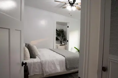 a bedroom with a bed with a ceiling fan at Maple Retreat with Big Pool in Dundee