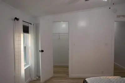 a bedroom with white walls and a white door at Maple Retreat with Big Pool in Dundee