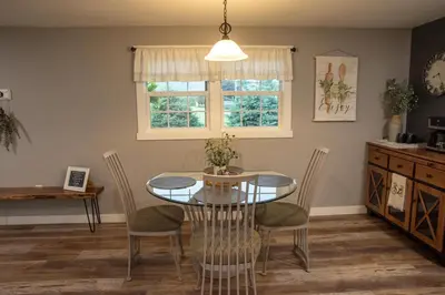 a dining room with a glass table and chairs at Haven on 41 in Warsaw