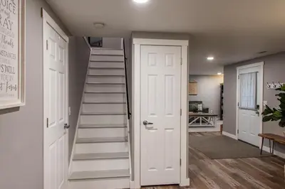 a staircase in a room with a white door at Haven on 41 in Warsaw
