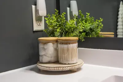 two vases sitting on a table in front of a mirror at Haven on 41 in Warsaw