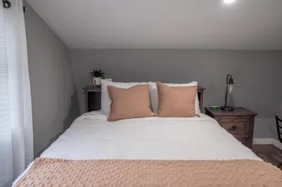 a bedroom with a large bed with white sheets and pillows at Haven on 41 in Warsaw