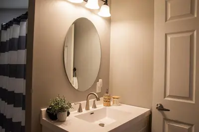 a bathroom with a sink and a mirror at Haven on 41 in Warsaw