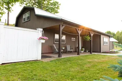 a house with a white fence in a yard at Haven on 41 in Warsaw