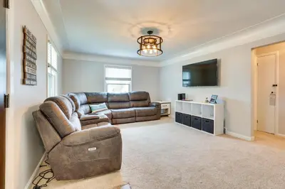 a living room with a couch and a television at Chippewa Lake Cottage with Fire Pit! in Chippewa Lake