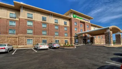a hotel with cars parked in a parking lot at Holiday Inn Express & Suites Pittsburgh SW/Southpointe by IHG in Canonsburg