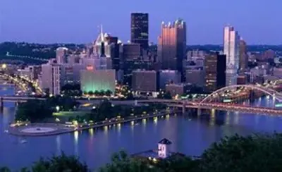 a city skyline with a river and a bridge at Holiday Inn Express & Suites Pittsburgh SW/Southpointe by IHG in Canonsburg