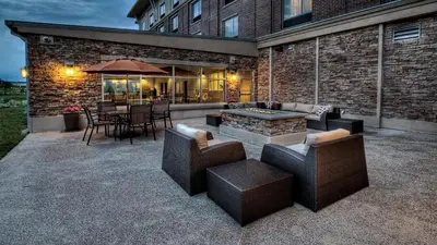 a patio with a table and chairs and a fire pit at Holiday Inn Express & Suites Pittsburgh SW/Southpointe by IHG in Canonsburg