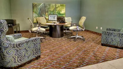 a room with chairs and a table with a computer at Holiday Inn Express & Suites Pittsburgh SW/Southpointe by IHG in Canonsburg