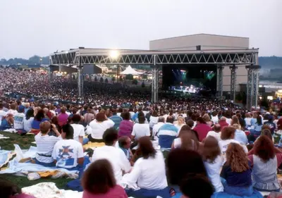 a large crowd of people sitting on the grass at a concert at Holiday Inn Express & Suites Pittsburgh SW/Southpointe by IHG in Canonsburg