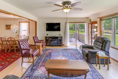 a living room with a couch and a table at WFH-Friendly Columbiana Vacation Rental with Deck! in Columbiana