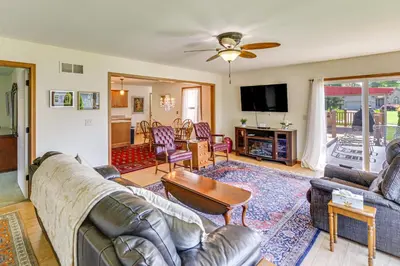 a living room with a couch and a table at WFH-Friendly Columbiana Vacation Rental with Deck! in Columbiana