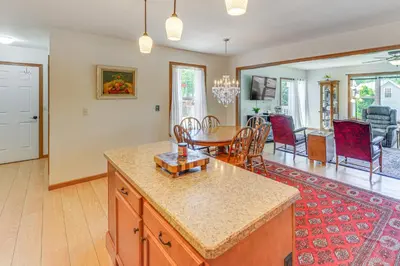a kitchen and living room with a table and chairs at WFH-Friendly Columbiana Vacation Rental with Deck! in Columbiana