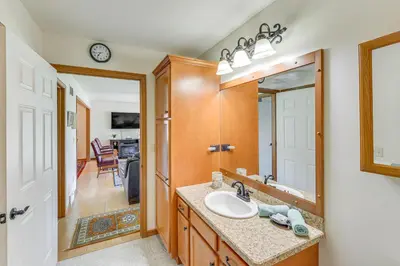 a bathroom with a sink and a mirror at WFH-Friendly Columbiana Vacation Rental with Deck! in Columbiana
