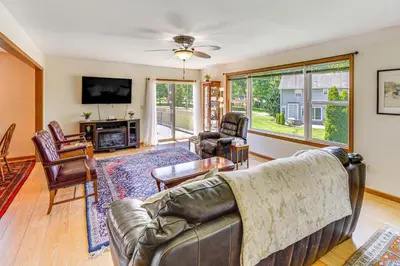 a living room with a couch and chairs and a tv at WFH-Friendly Columbiana Vacation Rental with Deck! in Columbiana