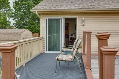 a chair sitting on the front porch of a house at WFH-Friendly Columbiana Vacation Rental with Deck! in Columbiana