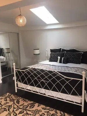 a bedroom with a bed with black and white pillows at Luxury three story apartment in SHORT NORTH in Columbus