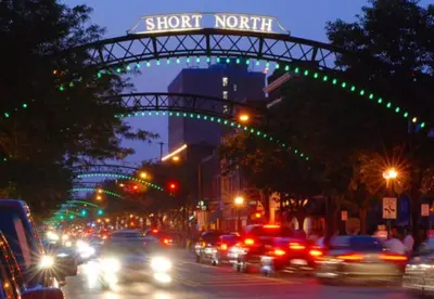 a busy city street with cars driving under a street sign at Luxury three story apartment in SHORT NORTH in Columbus