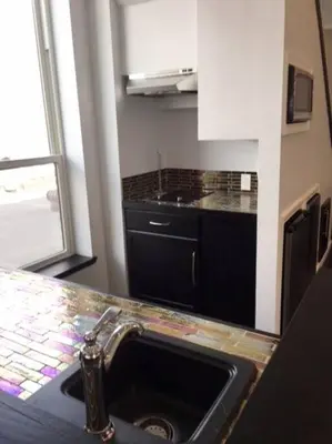 a kitchen with a sink and a counter top at Luxury three story apartment in SHORT NORTH in Columbus