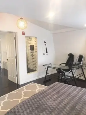 a bedroom with two chairs and a table and a bed at Luxury three story apartment in SHORT NORTH in Columbus