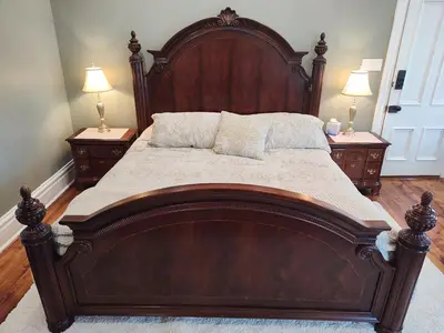 a large wooden bed in a bedroom with two night stands at Hickory House B & B in Hickory
