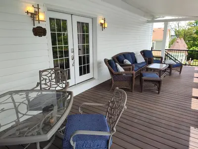 a porch with wicker chairs and a glass table at Hickory House B & B in Hickory