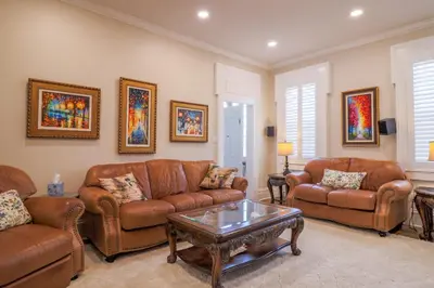 a living room with leather couches and a coffee table at Hickory House B & B in Hickory