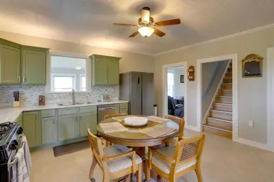 a kitchen with a table and a ceiling fan at Welcoming Port Clinton Vacation Rental! in Port Clinton