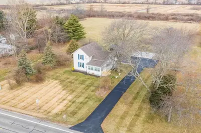 an aerial view of a white house with a driveway at Welcoming Port Clinton Vacation Rental! in Port Clinton