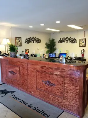 an office with a large wooden reception desk at Pacer Inn & Suites Motel in Delaware