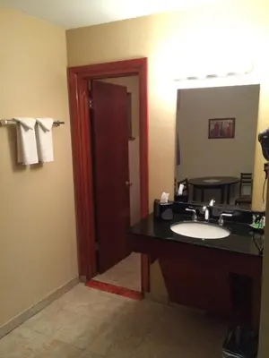 a bathroom with a sink and a mirror at Pacer Inn & Suites Motel in Delaware