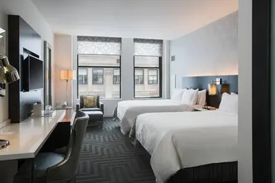a hotel room with two beds and a desk at Renaissance Cincinnati Downtown Hotel in Cincinnati