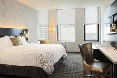 a hotel room with a bed and a desk at Renaissance Cincinnati Downtown Hotel in Cincinnati