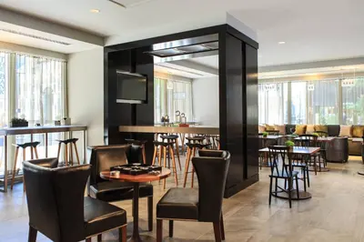 a restaurant with tables and chairs and a bar at Renaissance Cincinnati Downtown Hotel in Cincinnati