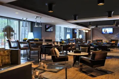 a restaurant with tables and chairs and a lobby at Renaissance Cincinnati Downtown Hotel in Cincinnati