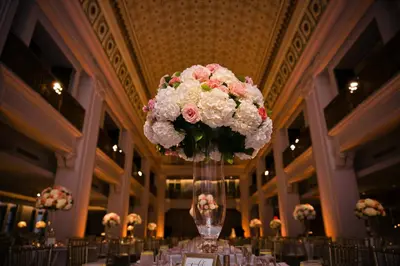 a vase filled with pink and white flowers on a table at Renaissance Cincinnati Downtown Hotel in Cincinnati