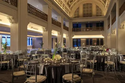 a ballroom with tables and chairs and a room filled at Renaissance Cincinnati Downtown Hotel in Cincinnati