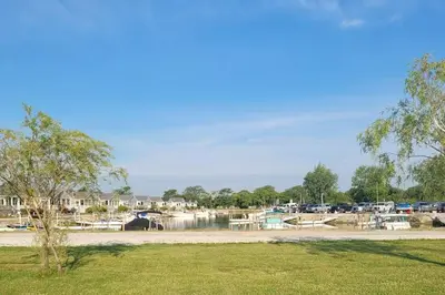 a body of water with boats in a marina at Sunnie Days condo in Oak Harbor on Lake Erie! in Sand Beach