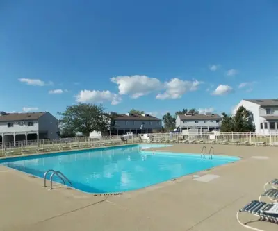 a large blue swimming pool in a resort at Sunnie Days condo in Oak Harbor on Lake Erie! in Sand Beach