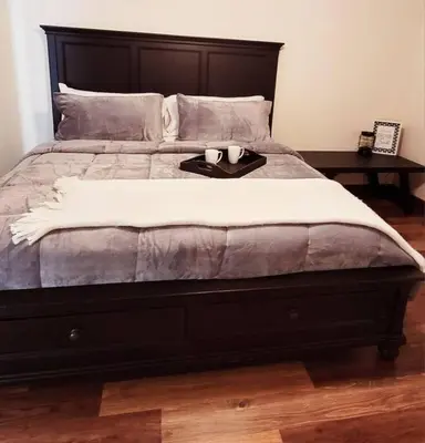 a bed with two candles on a tray on it at Sunnie Days condo in Oak Harbor on Lake Erie! in Sand Beach
