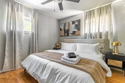 a bedroom with a large bed with a ceiling fan at Westlake Harmony in Westlake