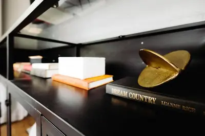 a table with a book and a butterfly trophy on it at Westlake Harmony in Westlake