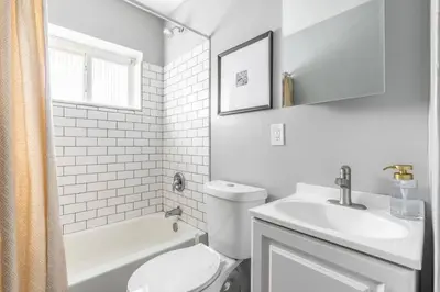 a white bathroom with a toilet and a sink at Westlake Harmony in Westlake