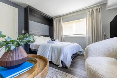 a hotel room with two beds and a couch at Westlake Apartment in Westlake
